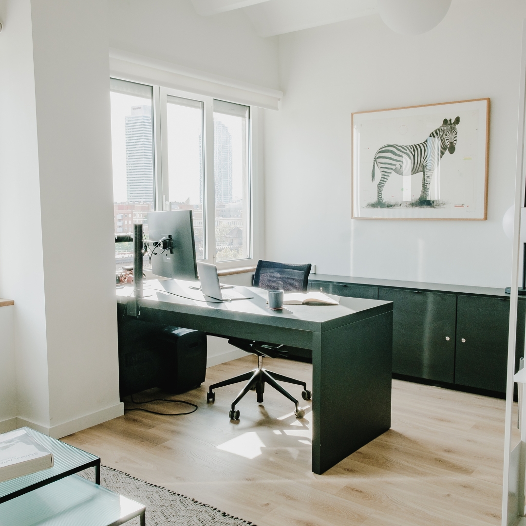White marketing office with black computer desk